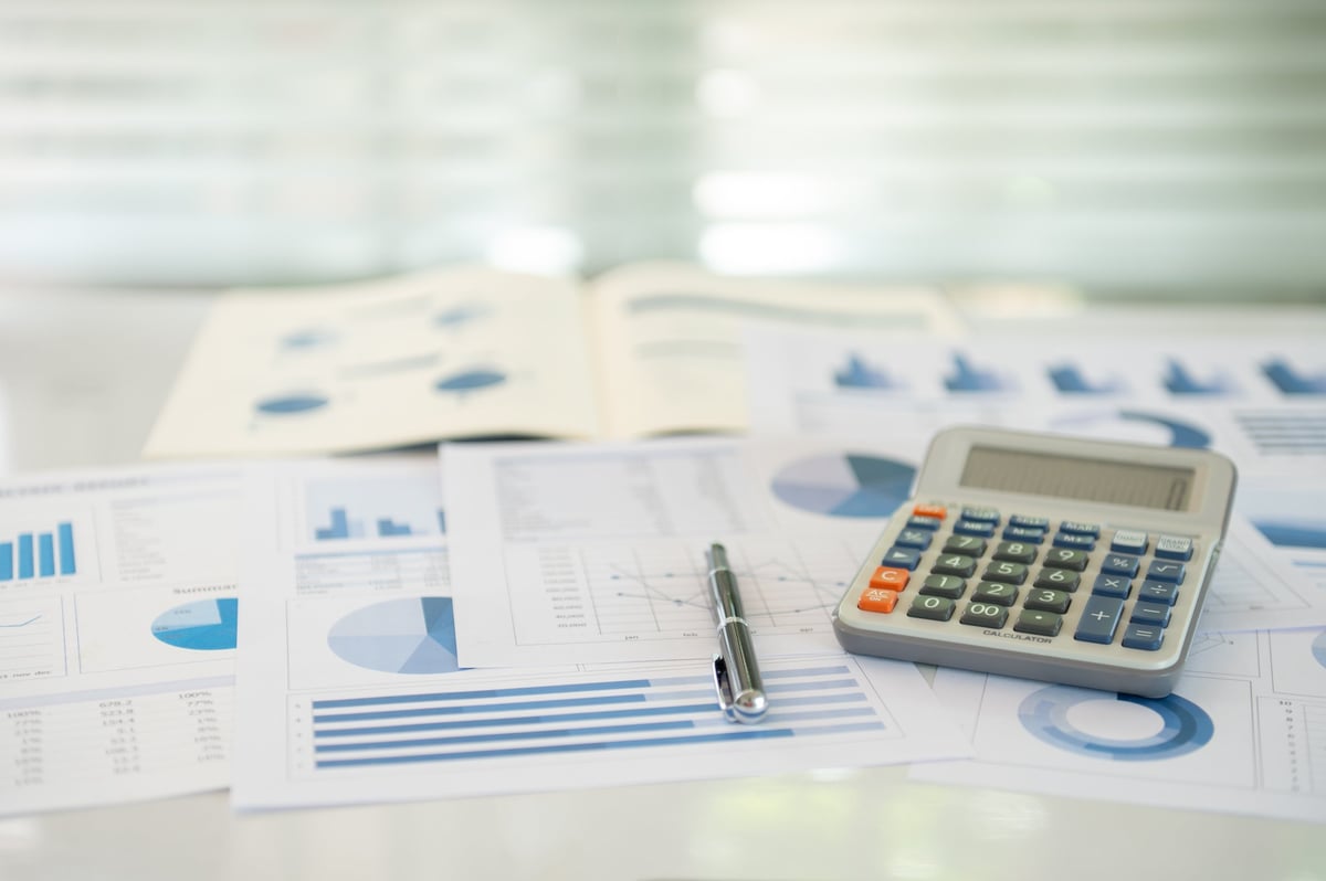 calculator, account statement and business report with review of year end reports. accounting business audit concept.